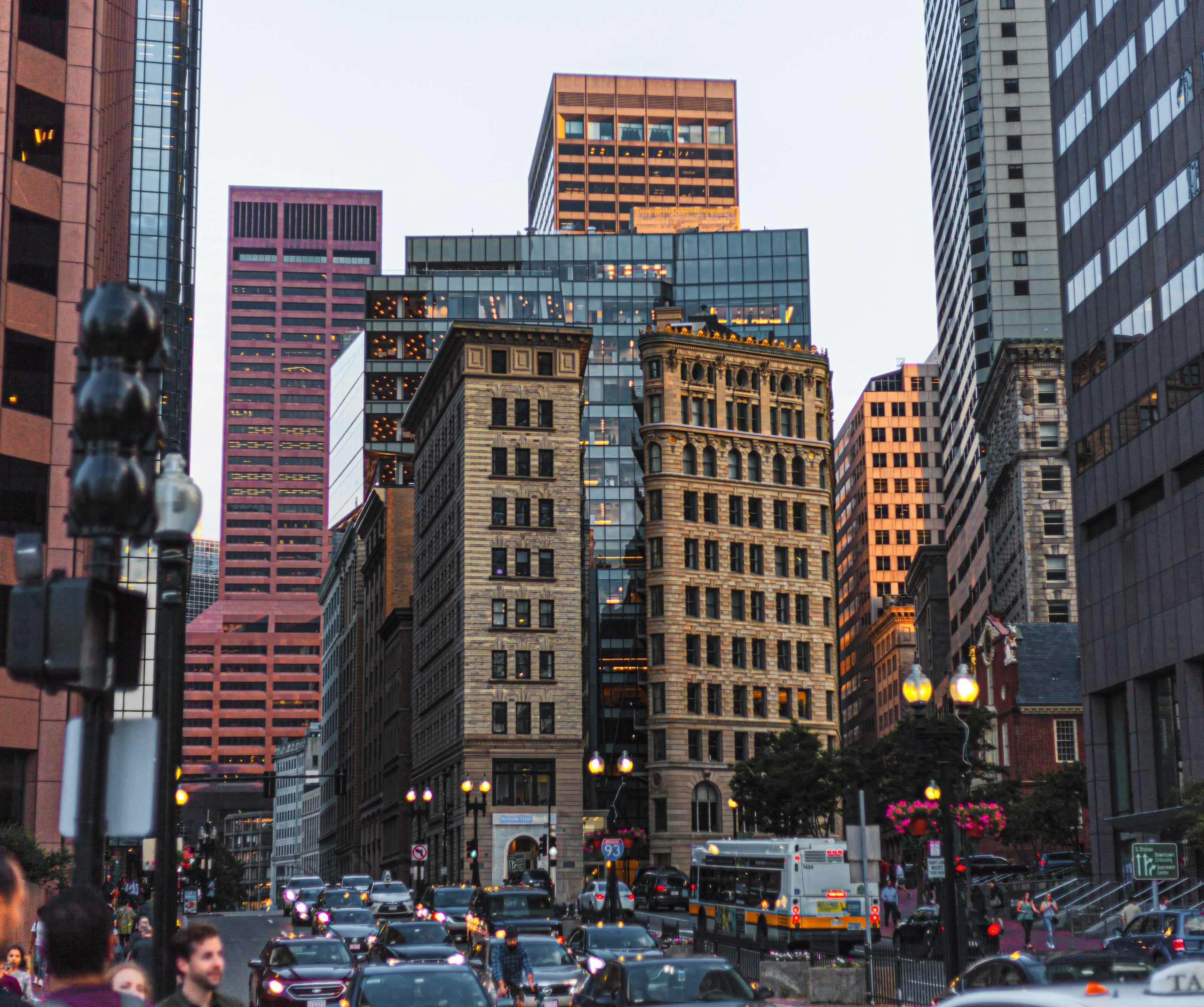 Bustling downtown Boston street scene showing where dirt originates before entering an office building