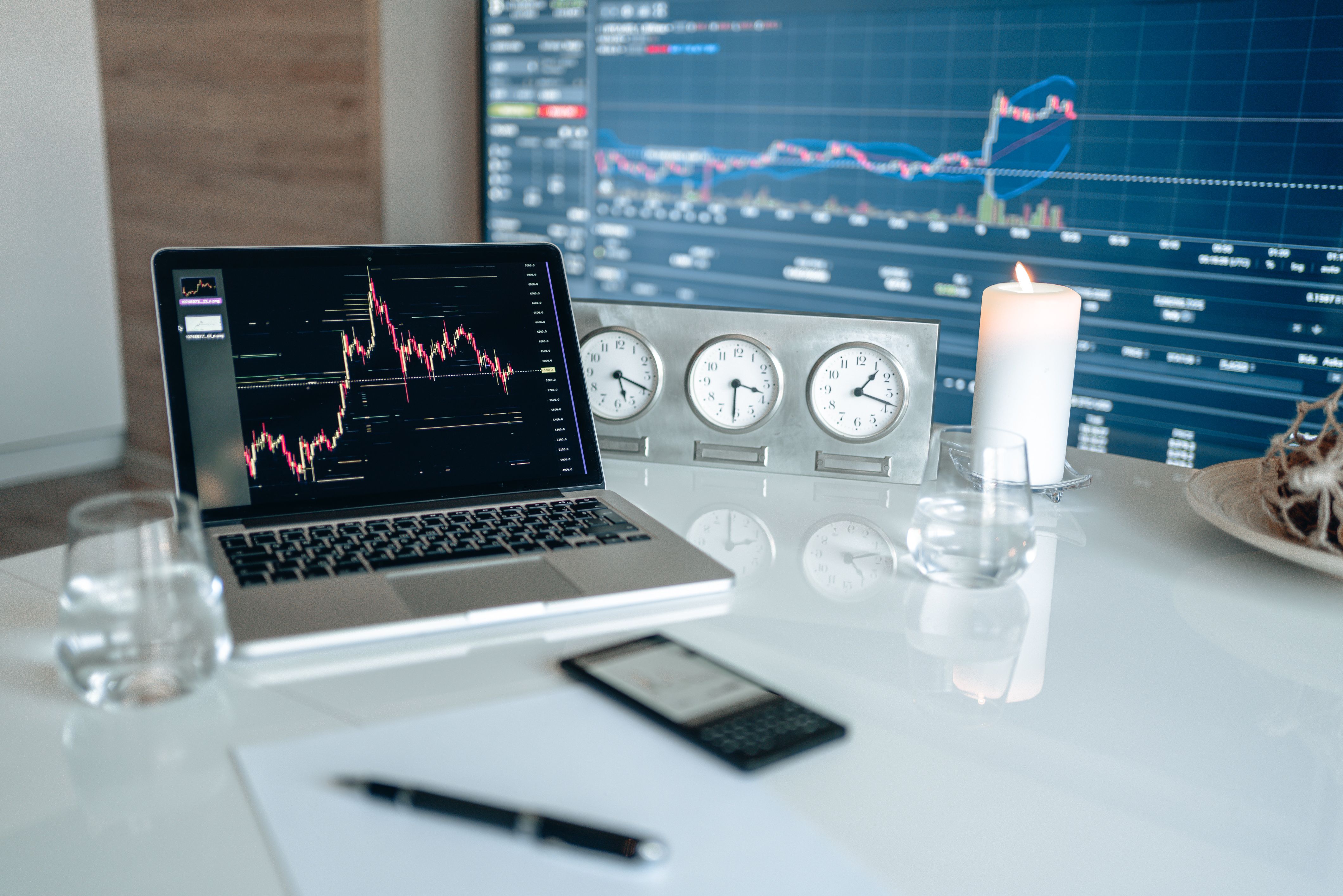 Financial analysis workspace with market charts and clocks, suggesting the global forex market's trading hours.